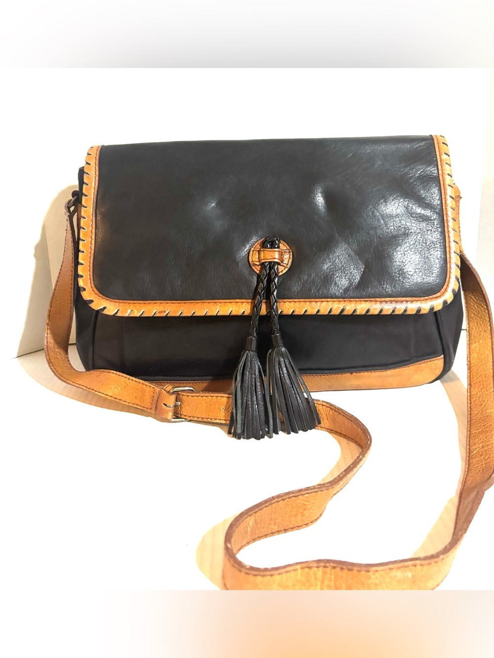 Black and Tan Leather Crossbody Bag with Tassel Accent